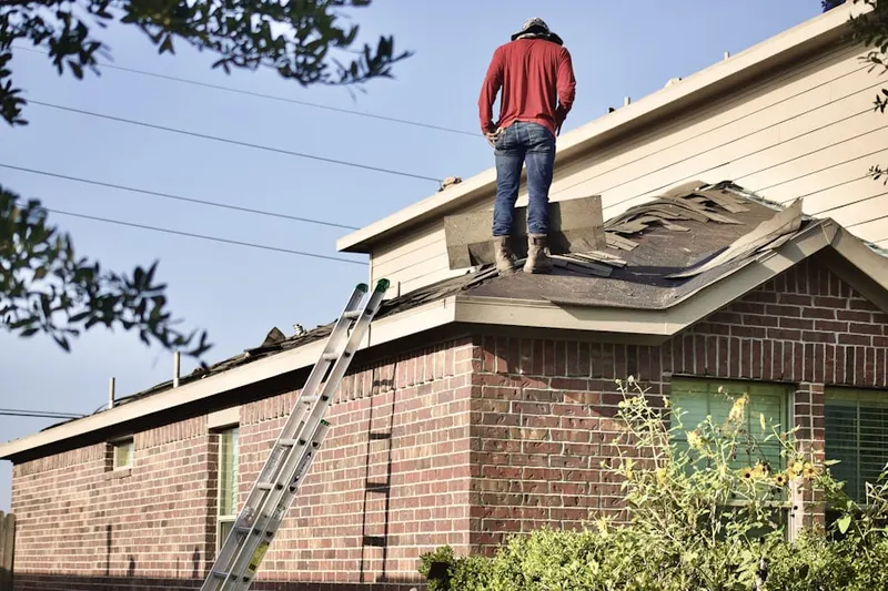Professional roofer working on a residential roof in Lucas